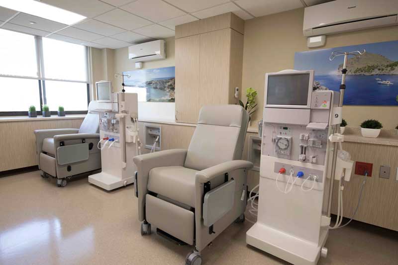 A modern dialysis treatment room equipped with comfortable reclining chairs and advanced dialysis machines, offering a clean and calming environment for patient care.